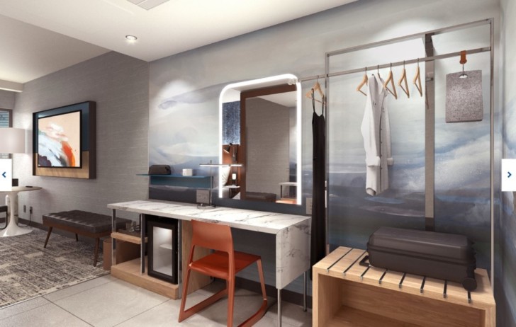 a room with a mirror and a chair