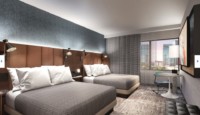 a room with two beds and a table