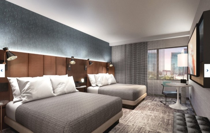 a room with two beds and a table