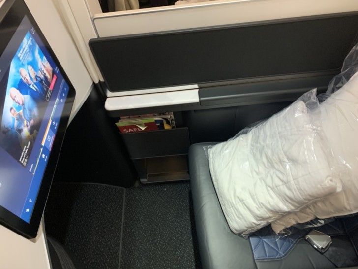 a computer screen and a pillow on a seat