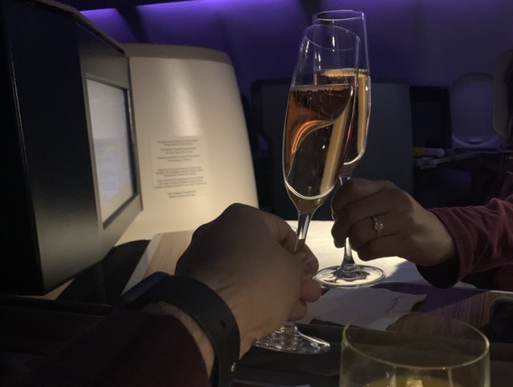 a couple of hands holding champagne glasses