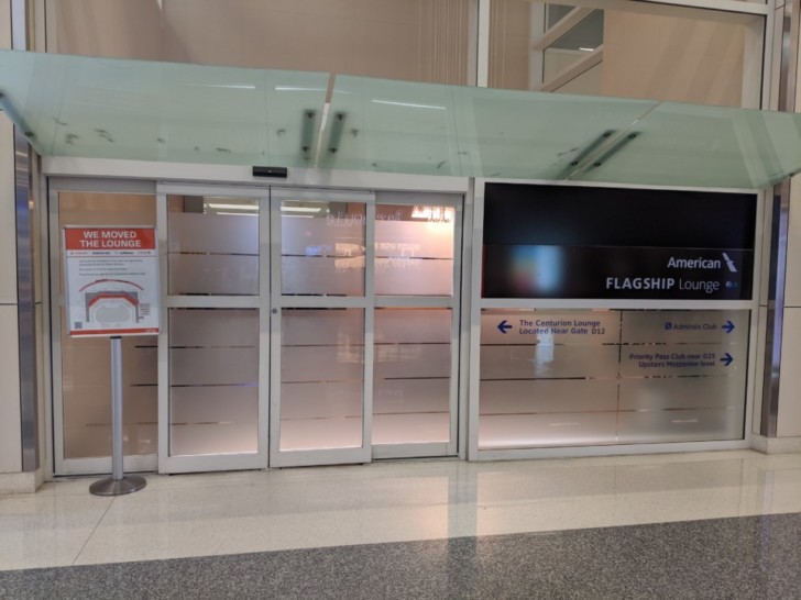 a glass doors with a sign in front of it