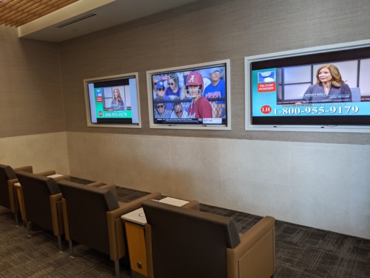 a room with several tvs on the wall