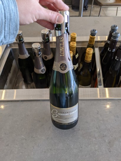 a hand holding a bottle of wine