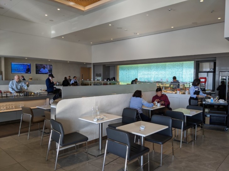 people sitting at tables in a restaurant