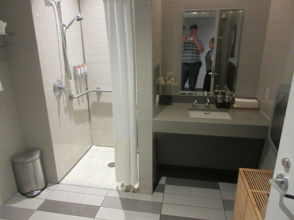 a bathroom with a shower and a mirror