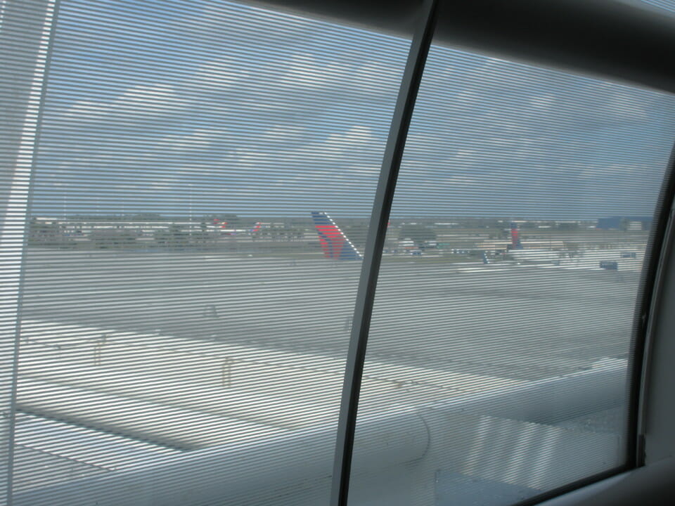 a window with a view of planes on the runway