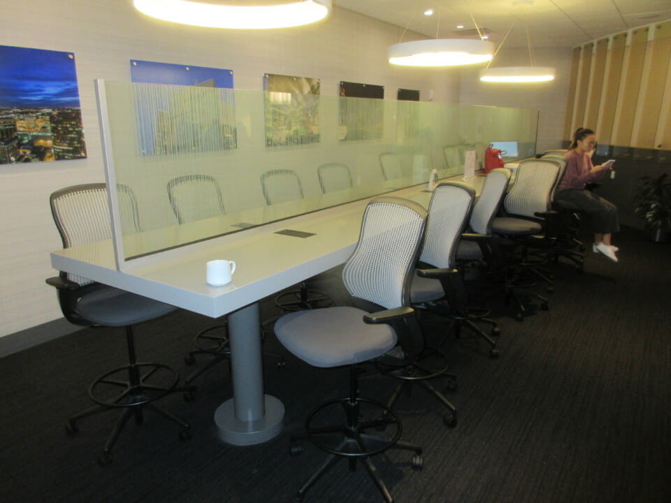 a long white table with a glass partition