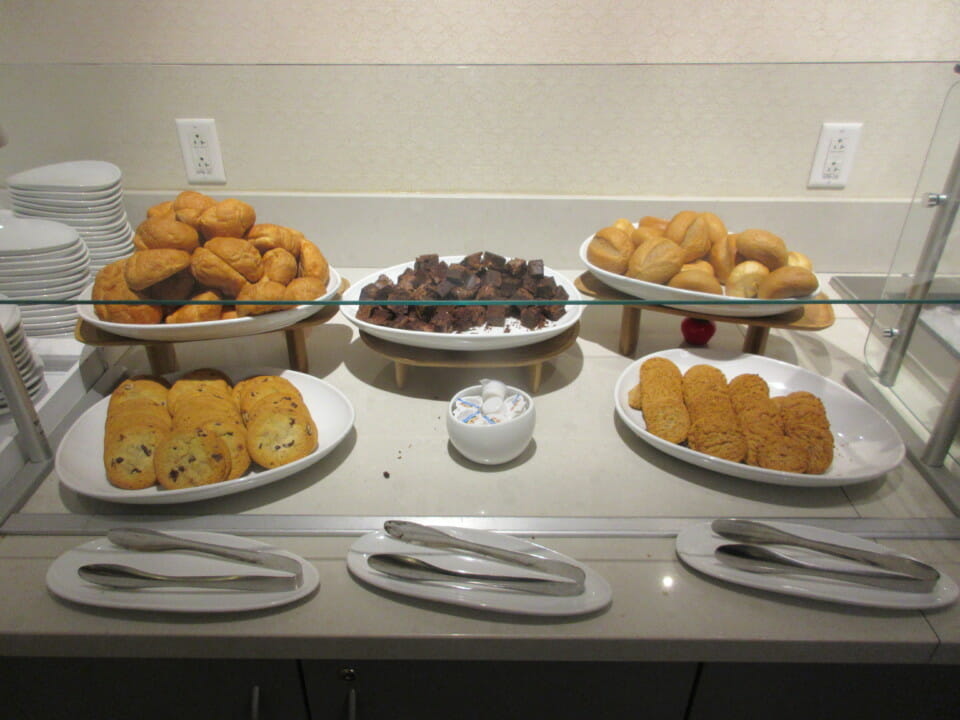 a buffet table with plates of food