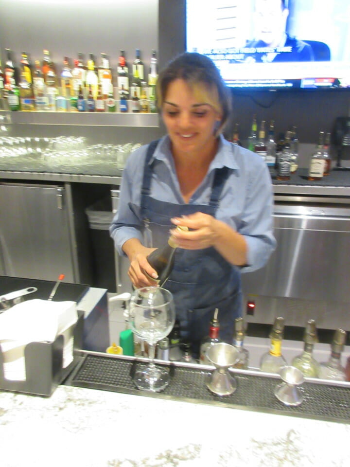 a woman pouring liquid into a glass