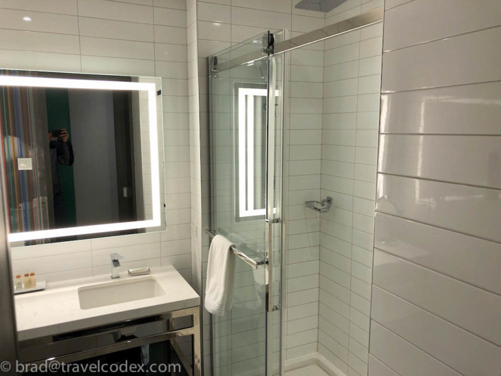 a bathroom with a mirror and a shower