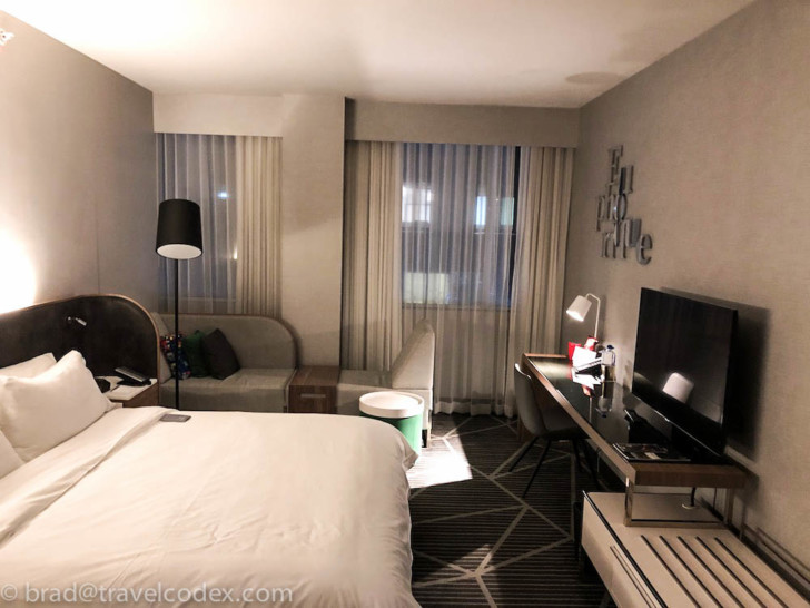 a room with a bed and a tv