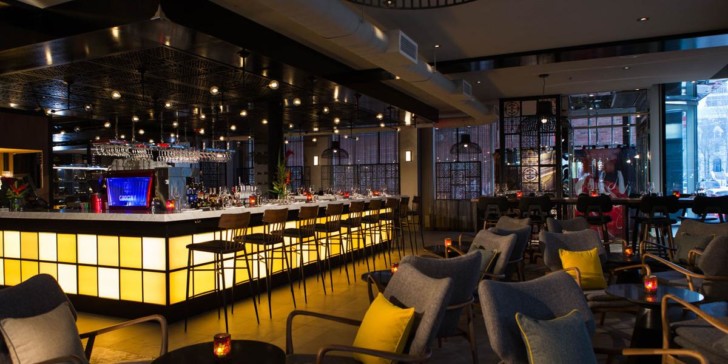 a bar with a long counter and chairs