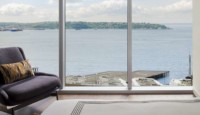a room with a large window overlooking the water