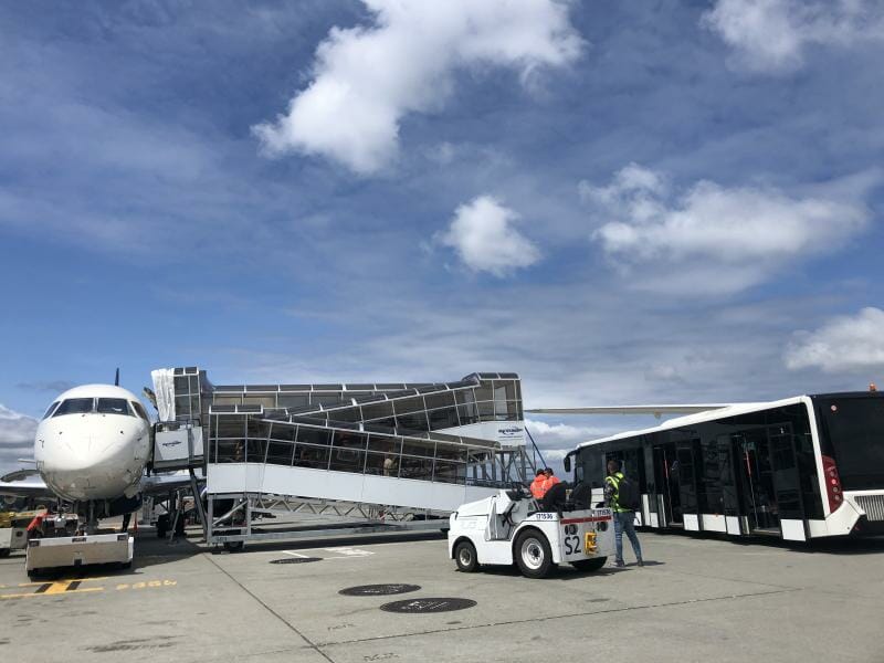 a plane and a bus at an airport