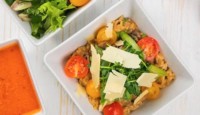 a bowl of food with tomatoes and cheese