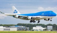 a blue and white airplane taking off