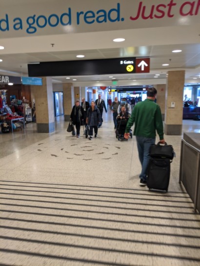 people walking in a building with luggage