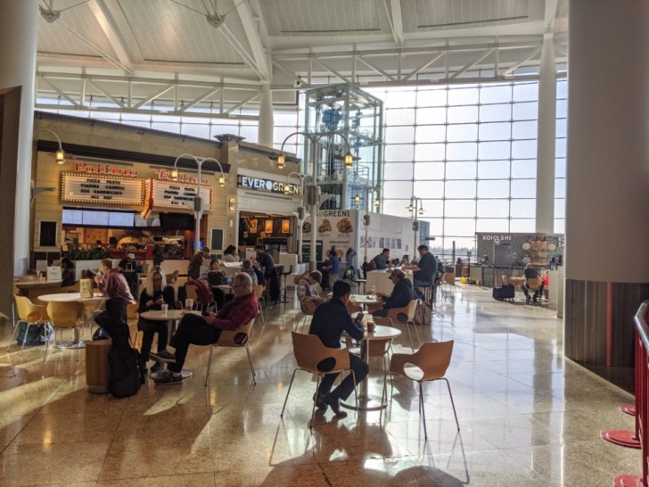 people sitting at tables in a large room
