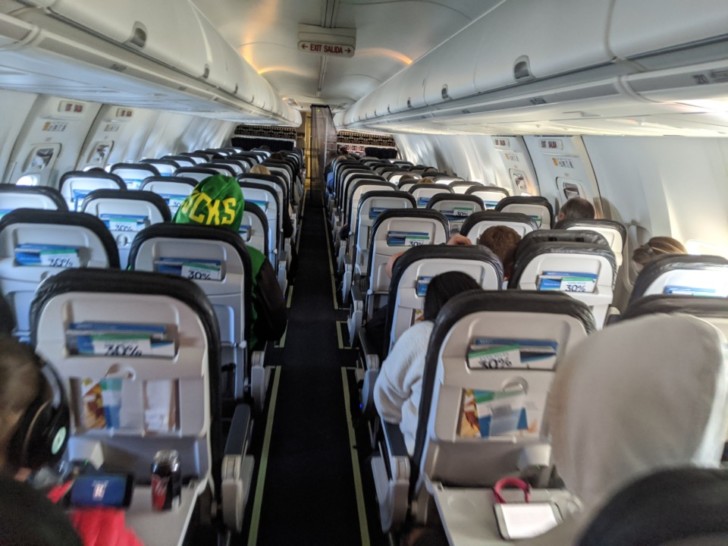 a group of people sitting in an airplane