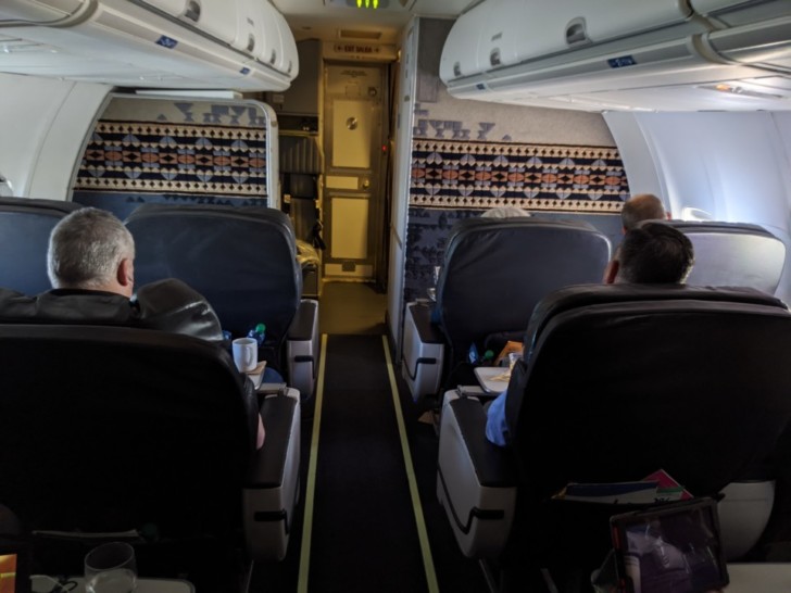 a group of people sitting in an airplane