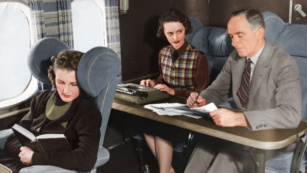 a man and woman sitting at a desk