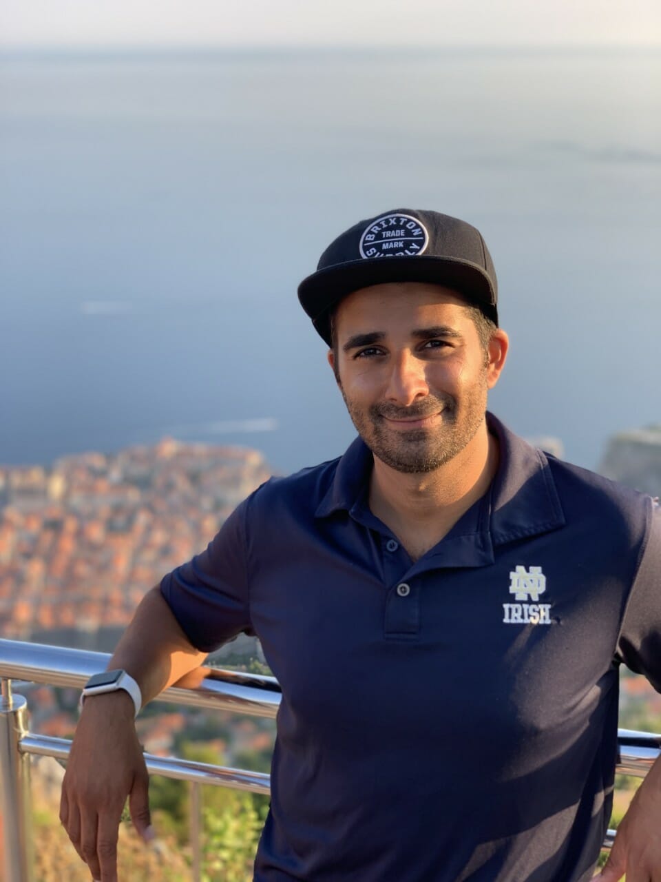 a man wearing a hat and smiling
