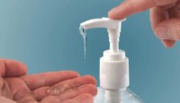 a person using a soap dispenser