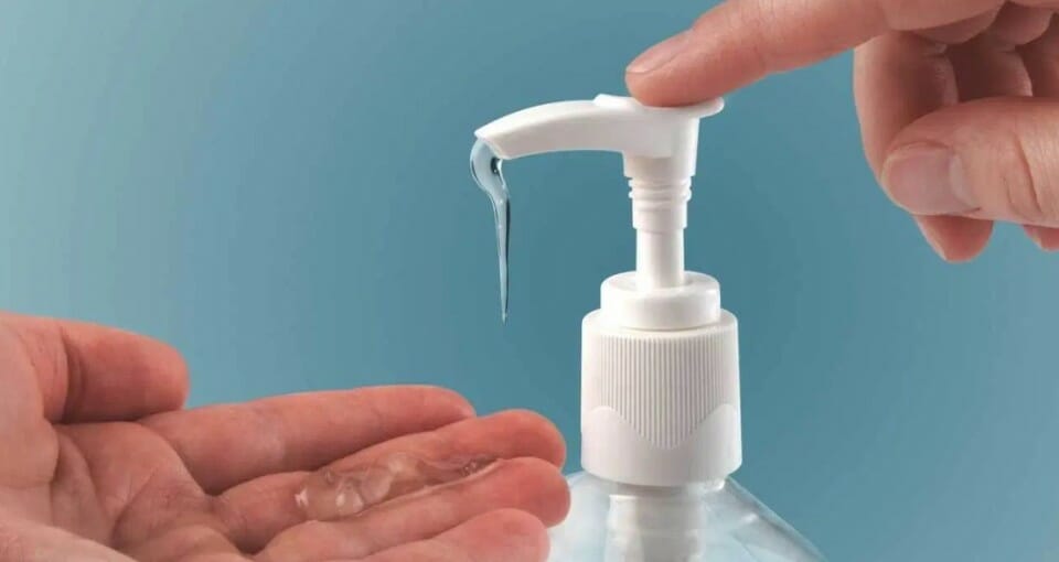 a person using a soap dispenser