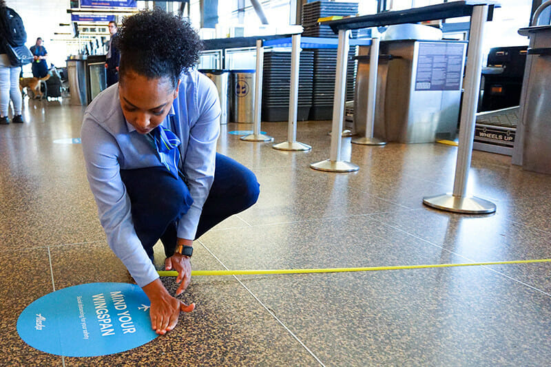 a woman measuring a circle on the floor