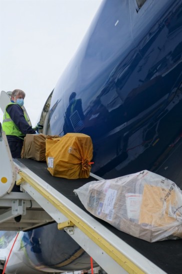 a man loading packages on a plane