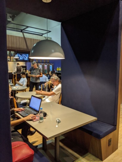 people sitting at a table with a laptop