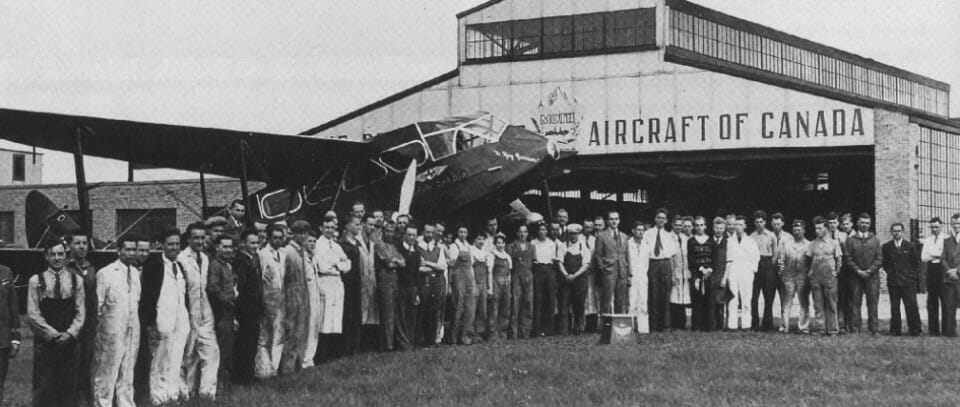 a group of people standing in front of an airplane
