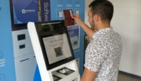 a man using a machine to check his passport
