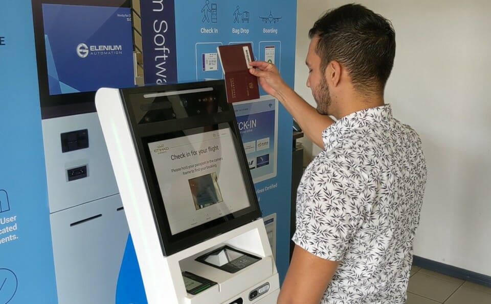 a man using a machine to check his passport