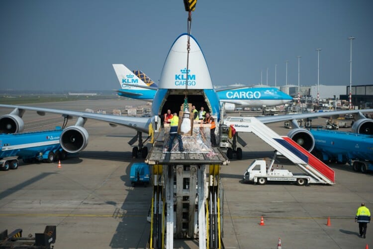 a group of people loading an airplane