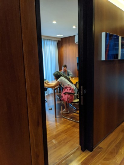 a woman sitting at a table with a man in a chair