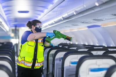a person spraying an object on an airplane