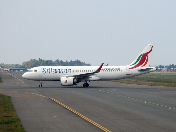 a white airplane on a runway