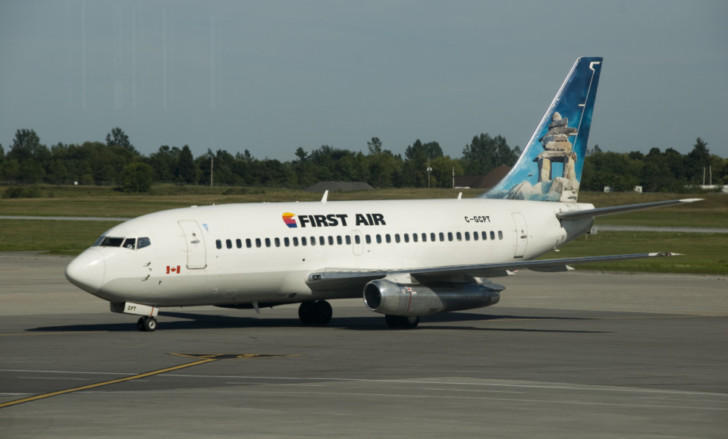 a white airplane on a runway