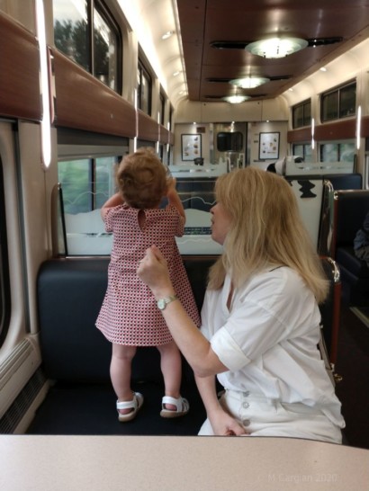 a woman holding a baby in a dress