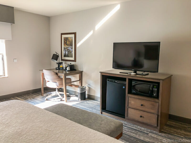 a room with a bed and a television
