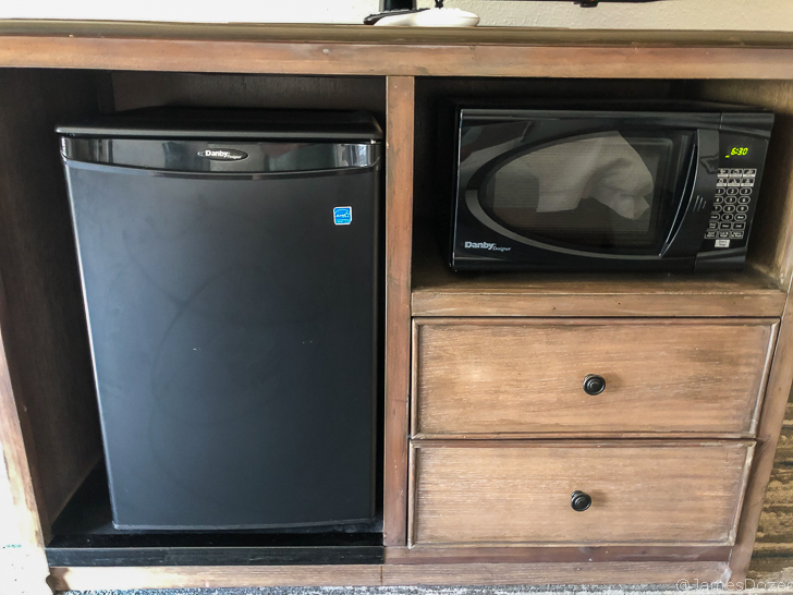 a microwave and a refrigerator on a shelf