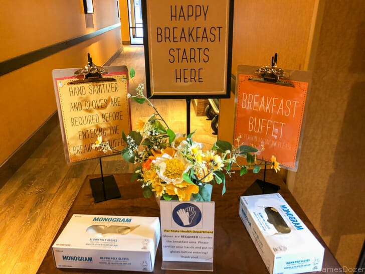 a table with a sign and flowers