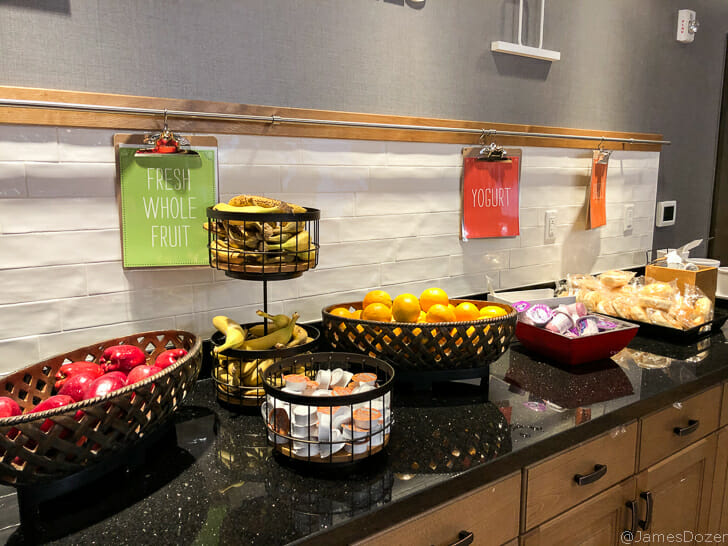 a group of fruit in baskets on a counter