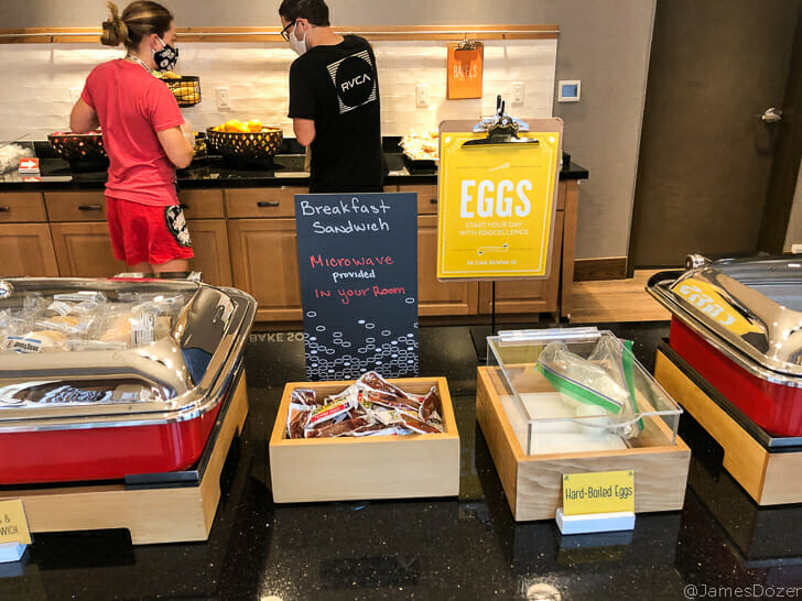 people in a room with food in containers