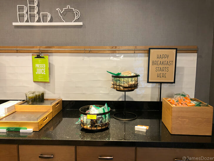 a breakfast buffet with a sign