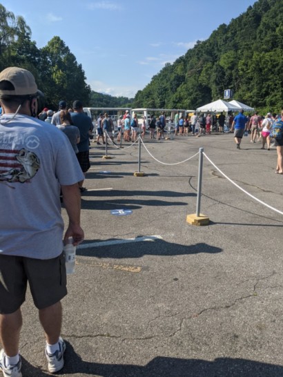 a group of people standing in a parking lot
