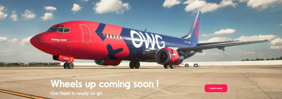 a blue and red airplane on a runway