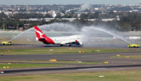a jet plane spraying water on runway